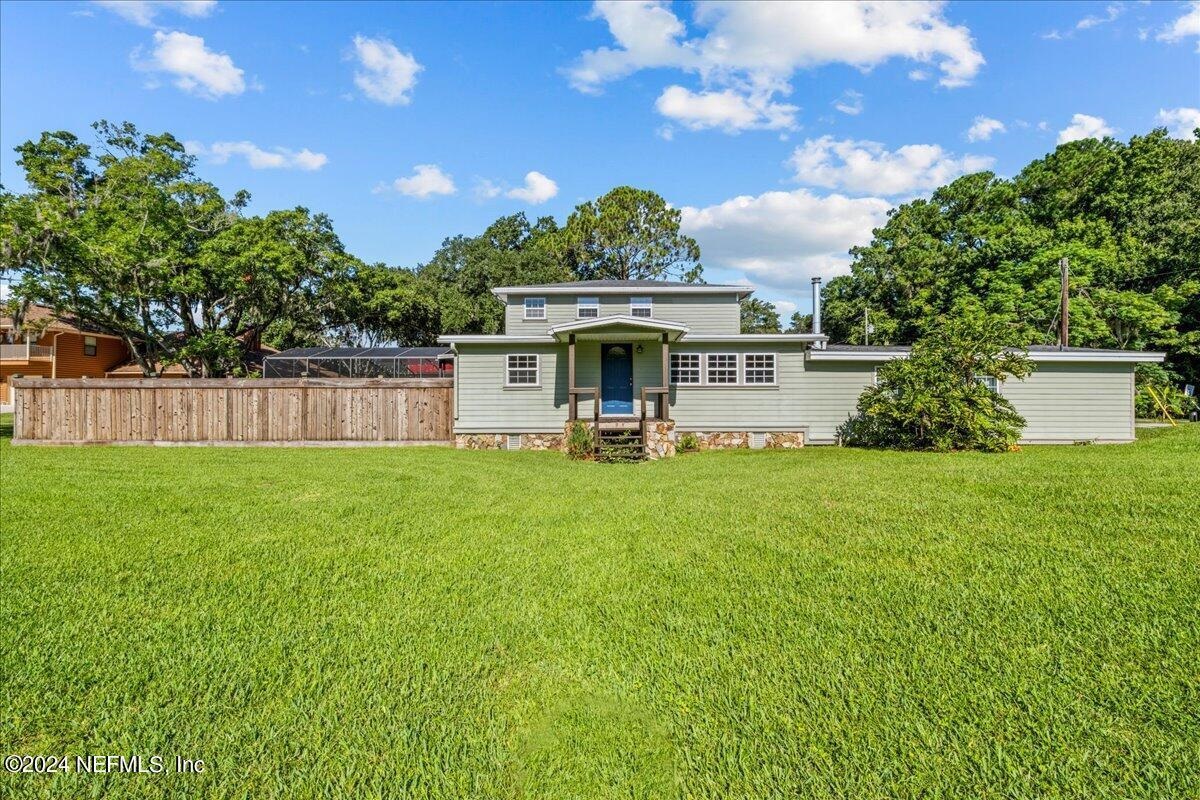 a front view of house with yard and outdoor seating