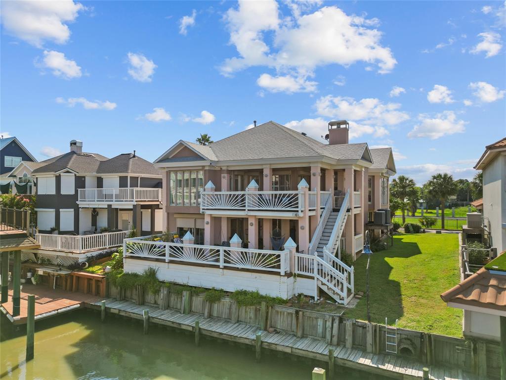 a front view of a house with swimming pool having outdoor seating