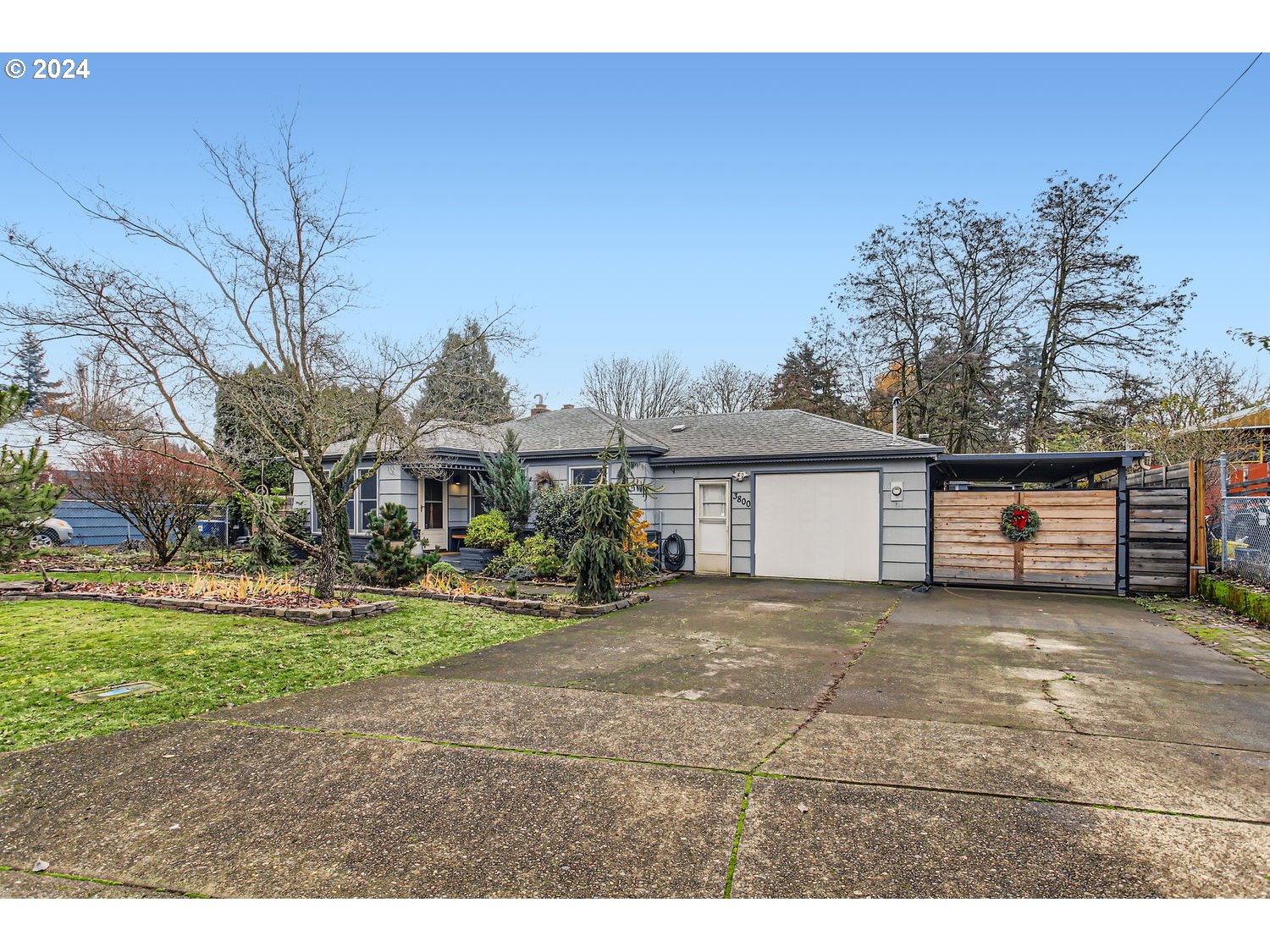 a view of a house with a yard and potted plants