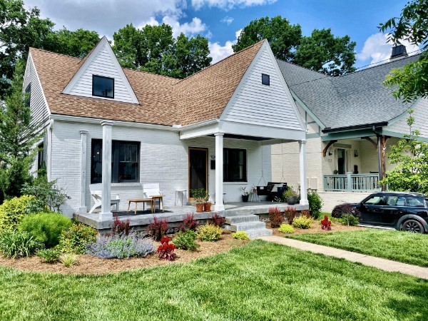 a front view of house with outdoor seating and yard