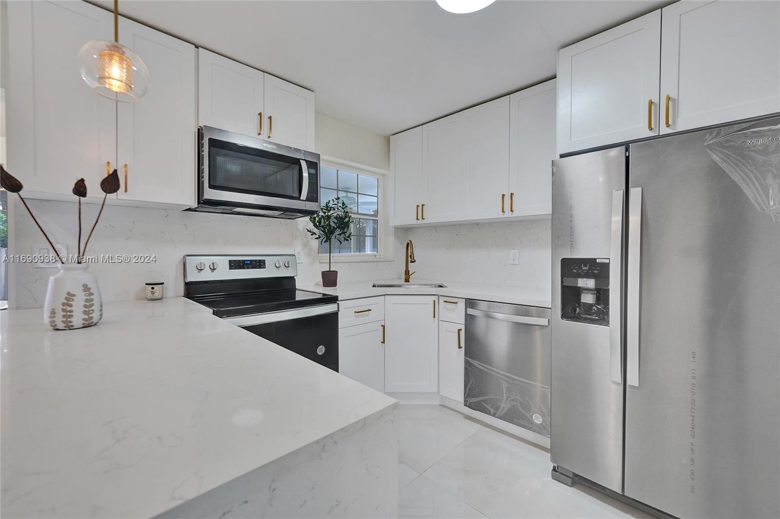 a kitchen with refrigerator a microwave a stove and cabinets