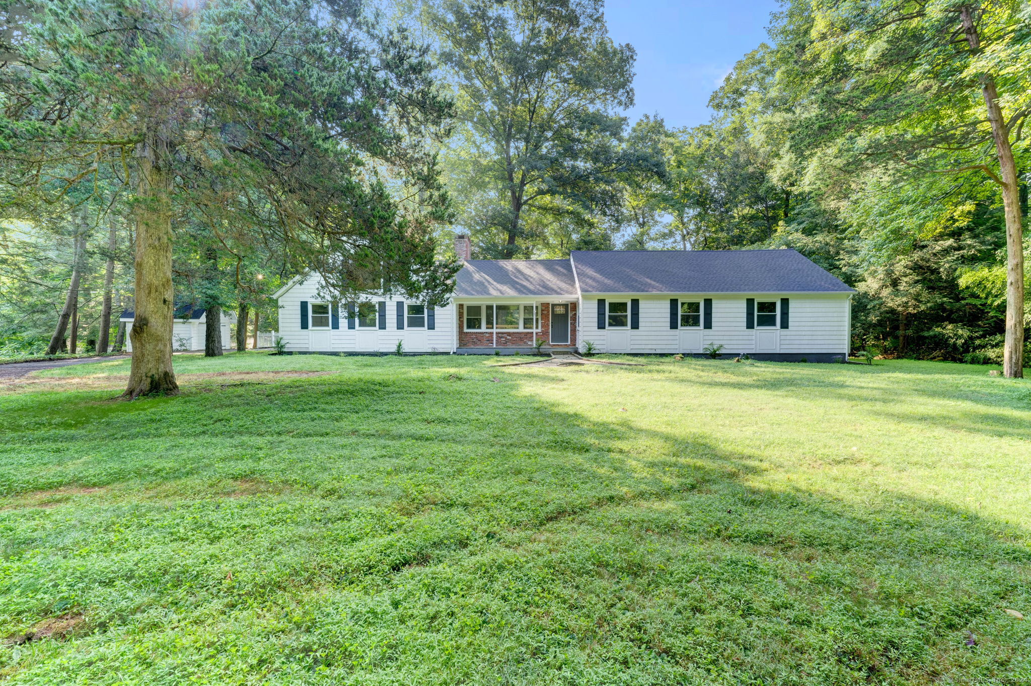 a front view of a house with a garden