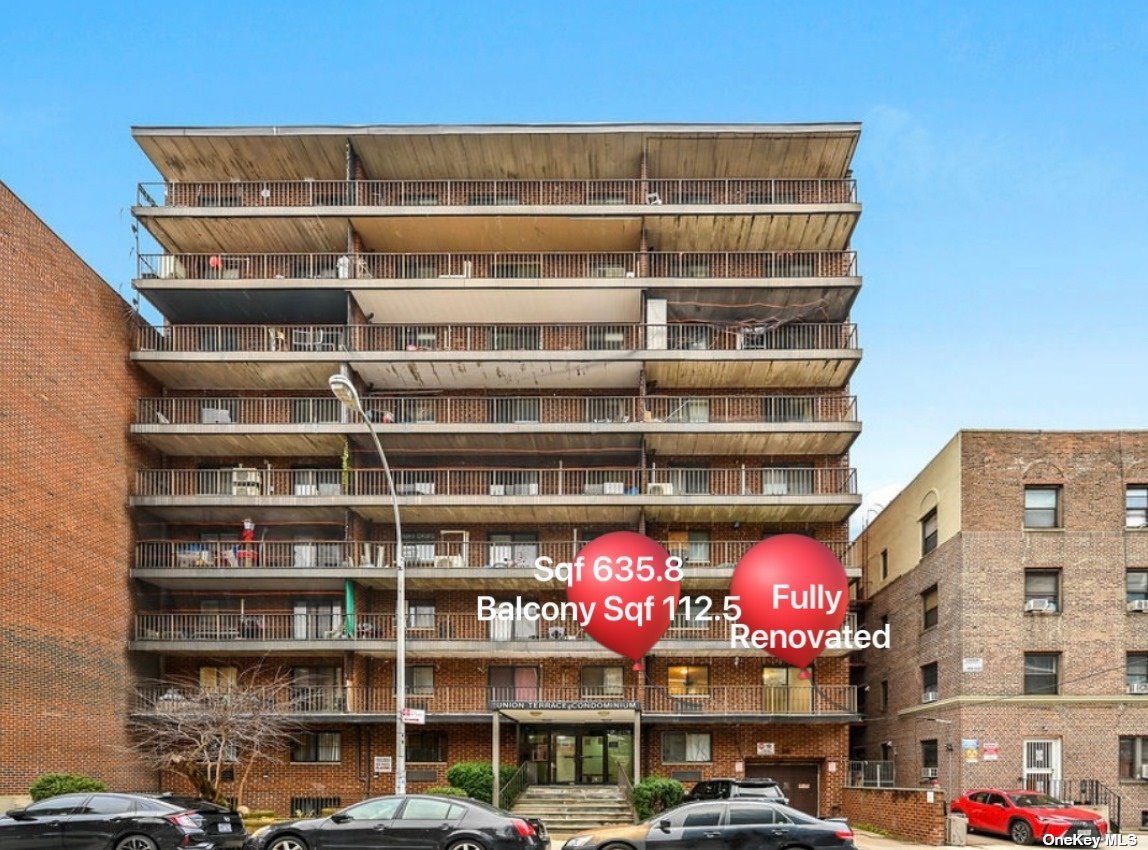 a front view of multi story residential apartment building with parking space