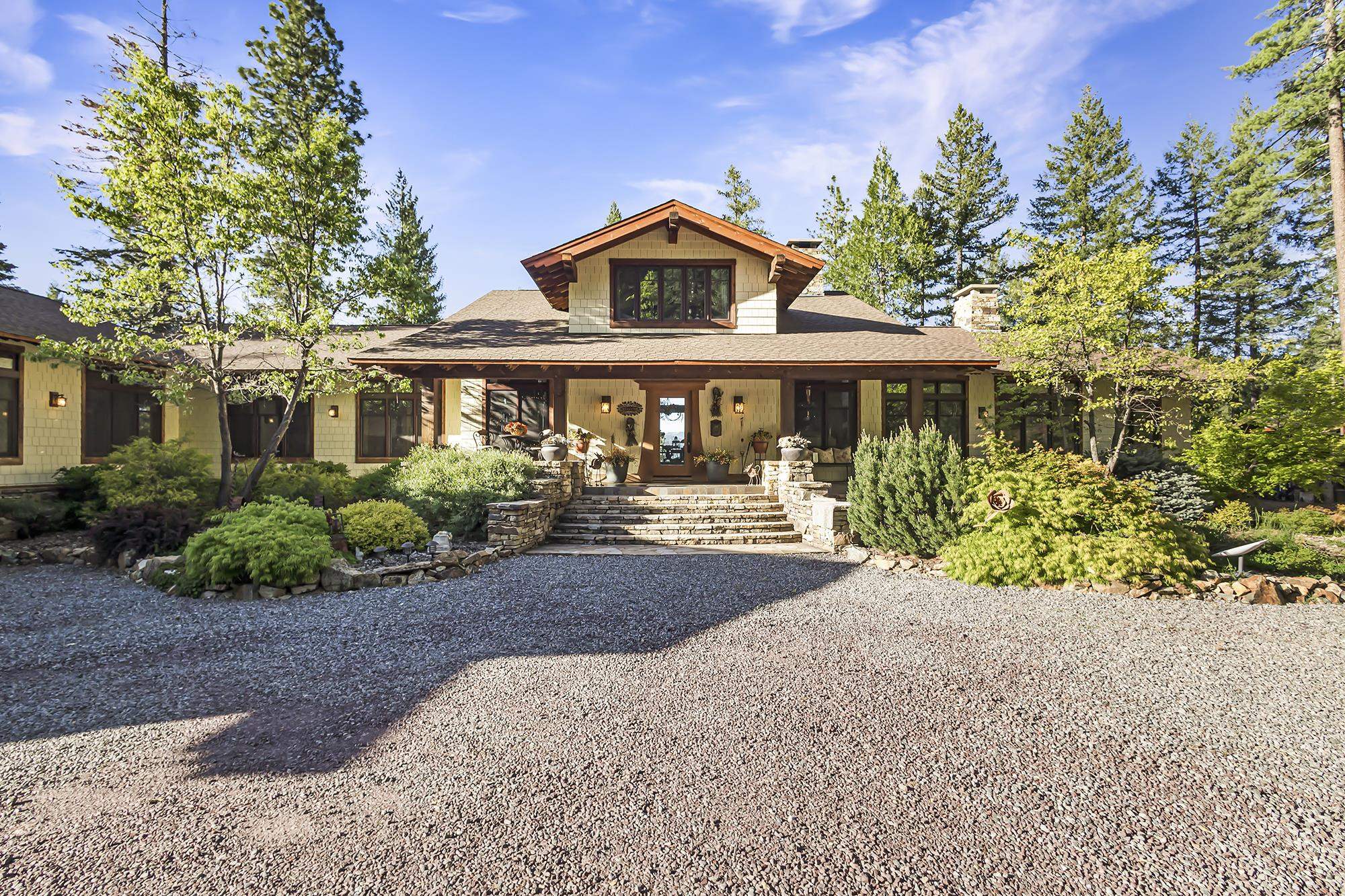 a front view of a house with a yard and outdoor seating