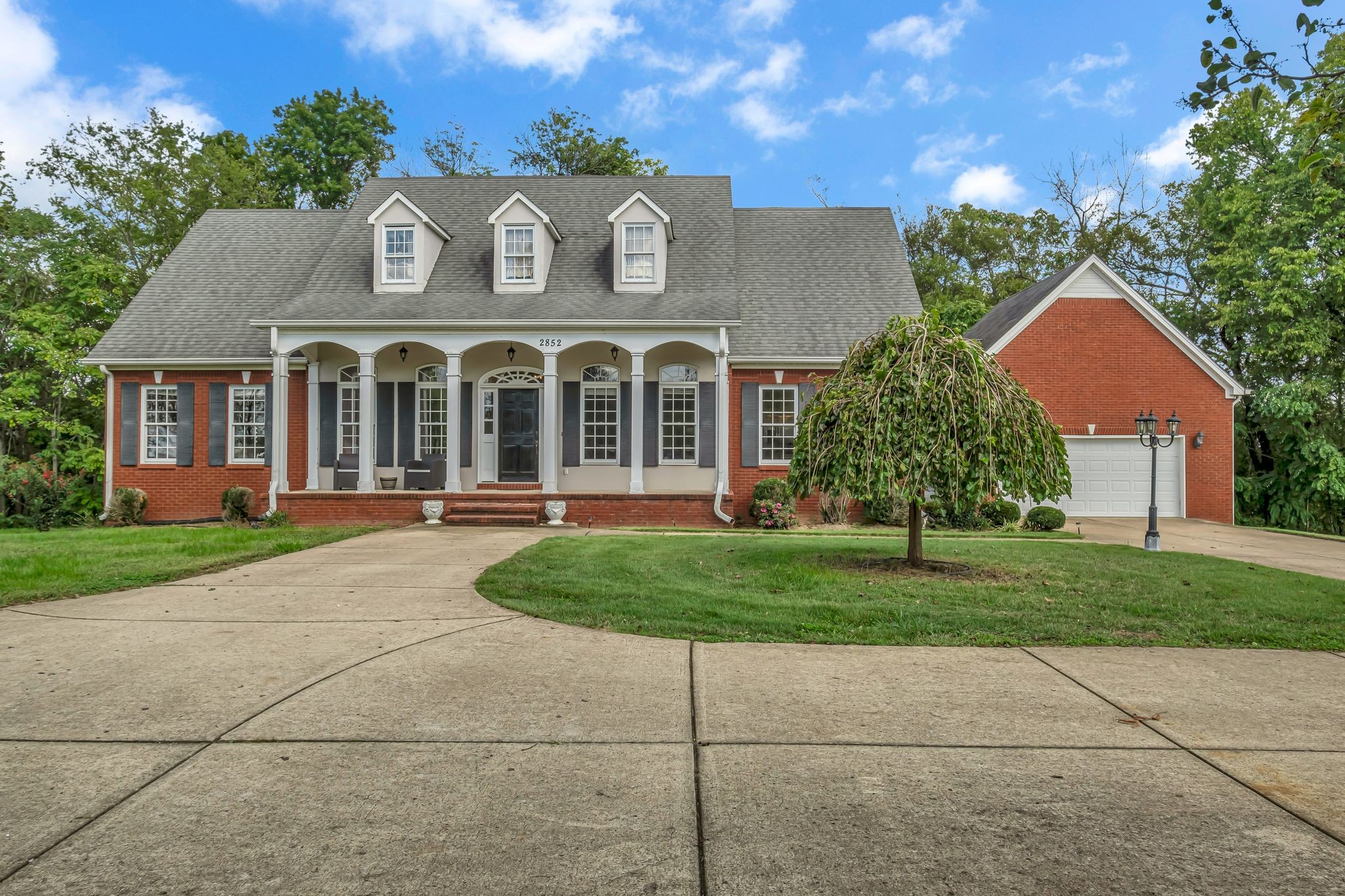 a front view of a house with a garden