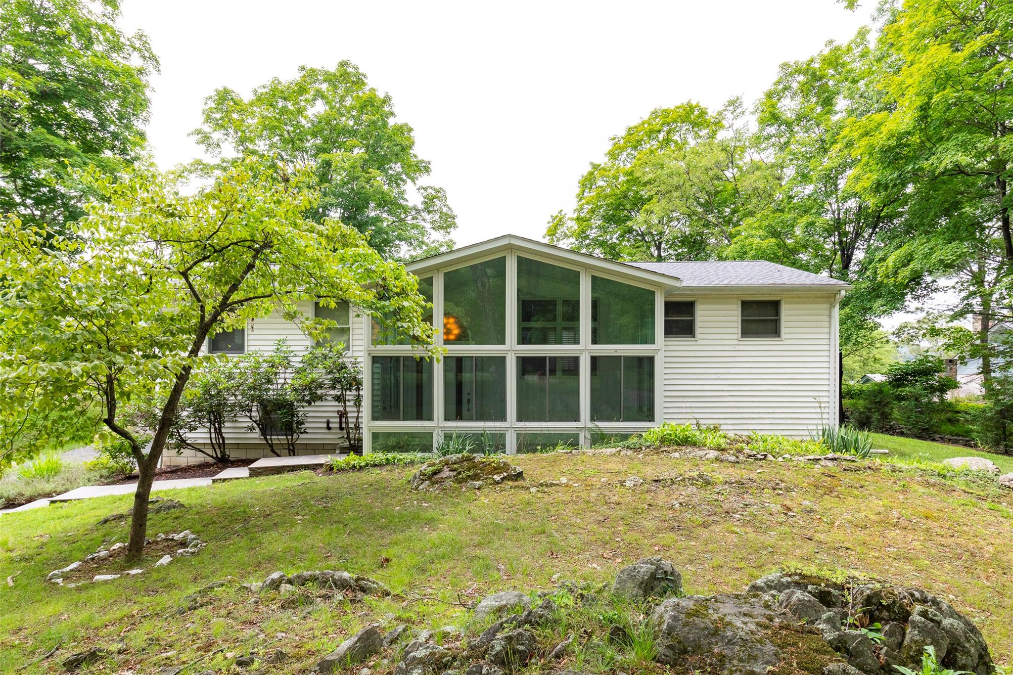 a large tree in front of a house