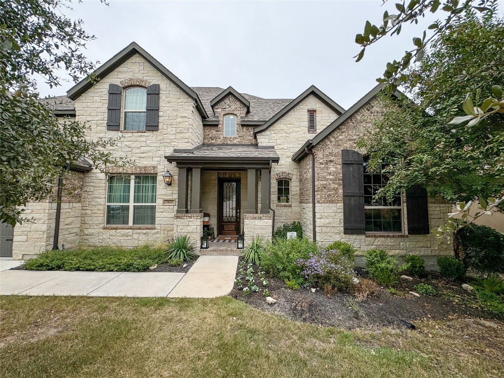 a front view of a house with garden