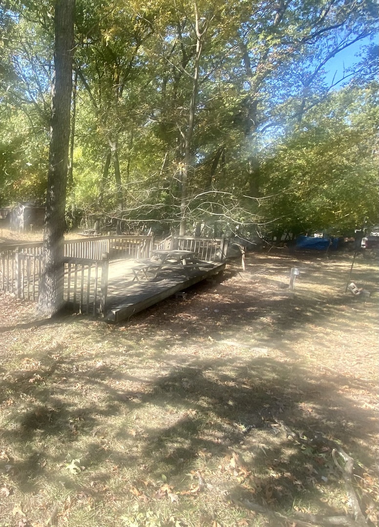 a view of a water with trees all around