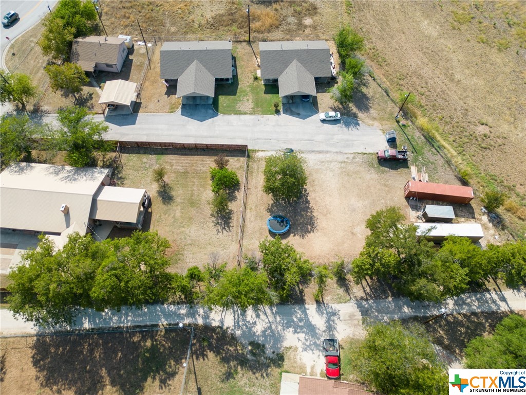 an aerial view of a house with a yard and lake view