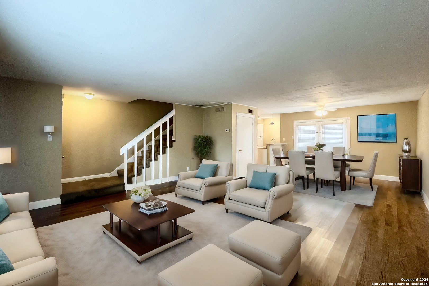 a living room with furniture and wooden floor