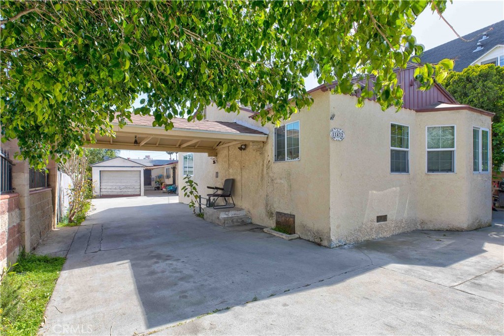 a view of a house with a tree and a yard