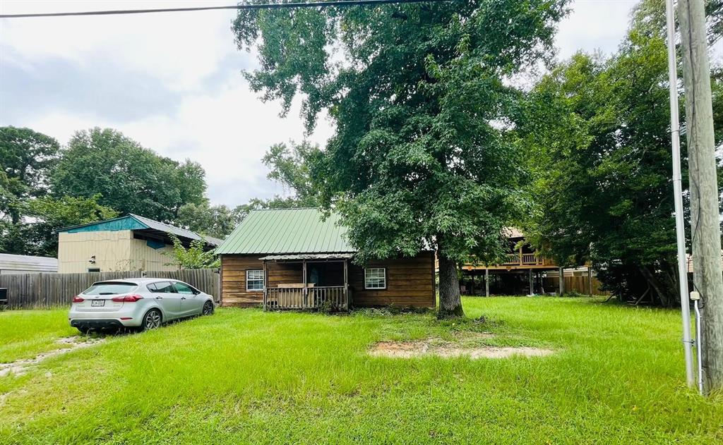 a front view of a house with a yard and green space