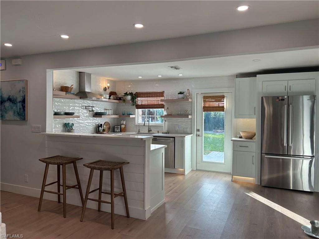 a kitchen with refrigerator and microwave