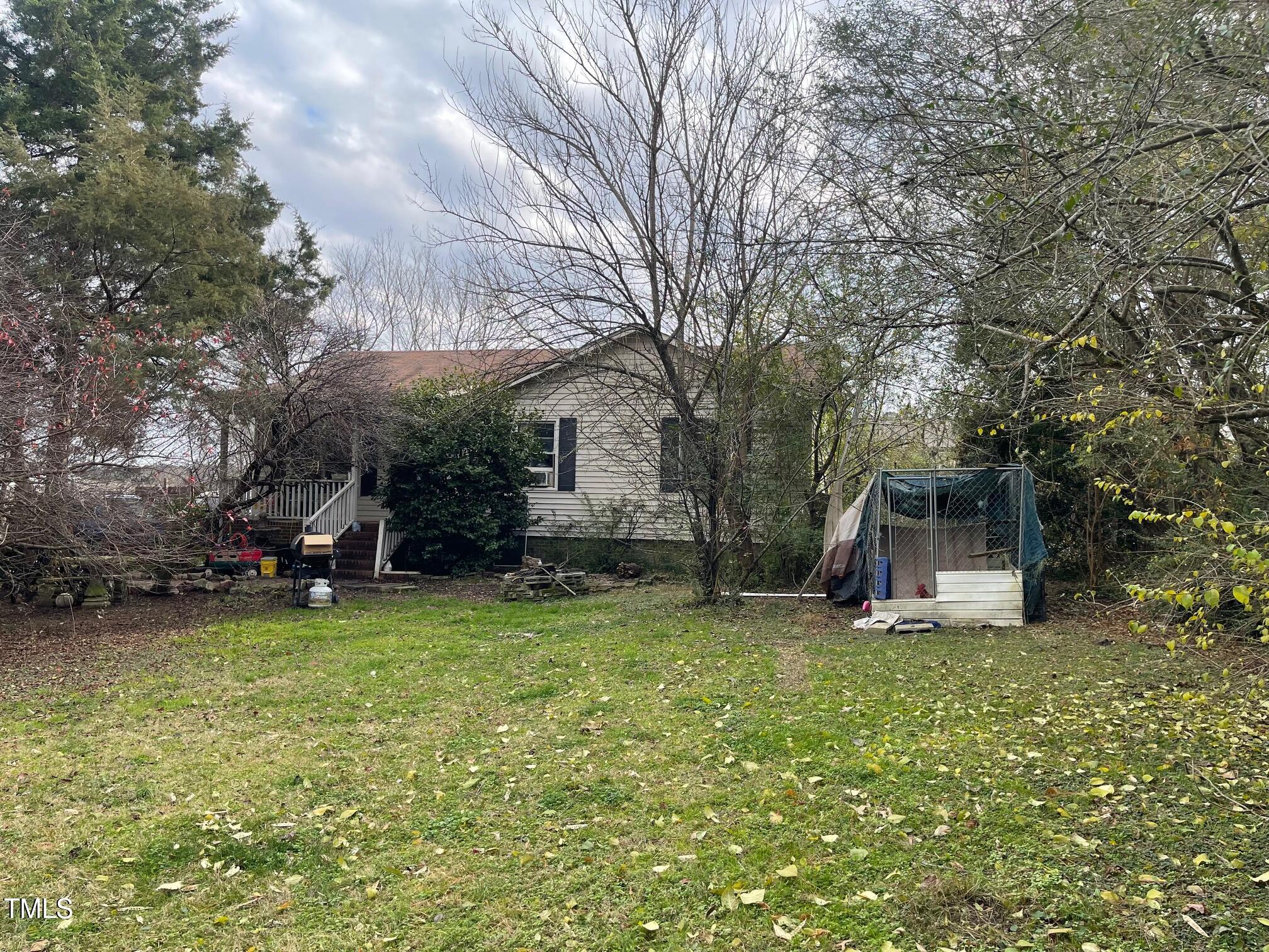 a view of a house with a yard garage and sitting area