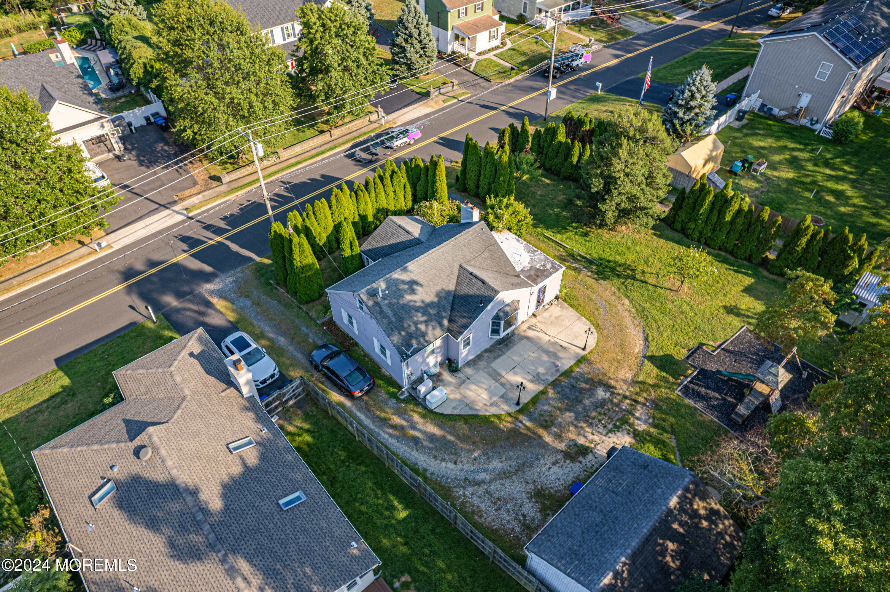 an aerial view of a house with a yard basket ball court and outdoor seating