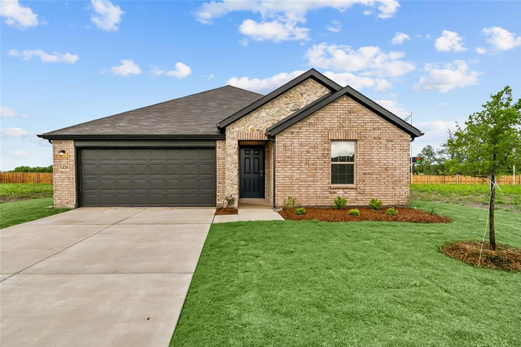 a front view of house with yard and green space