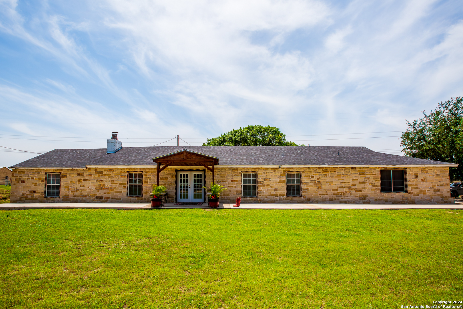 a front view of a house with a big yard