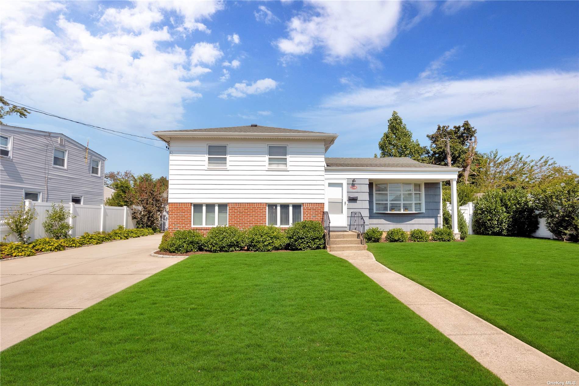 a front view of house with yard and green space