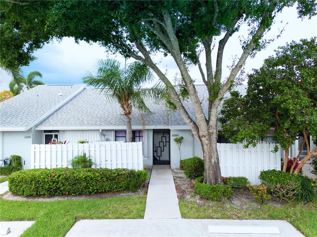 a front view of a house with a yard and trees