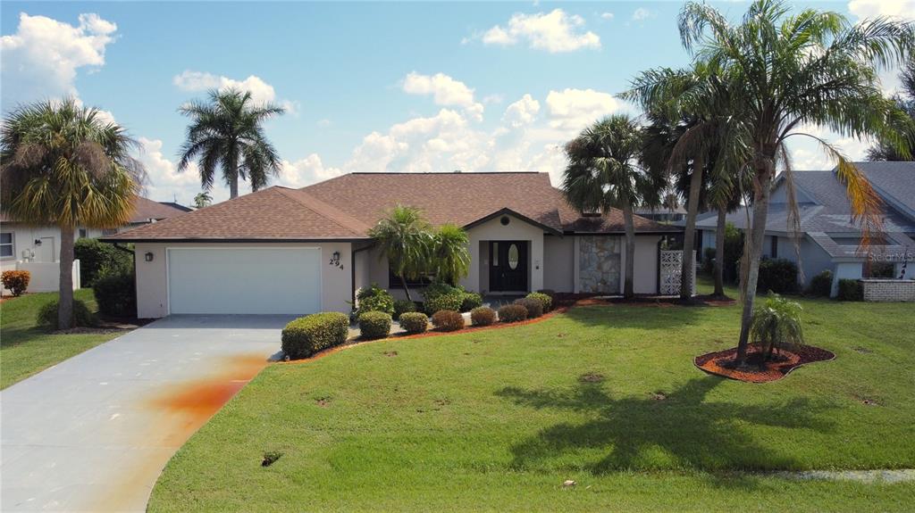 a view of a house with a patio and a yard