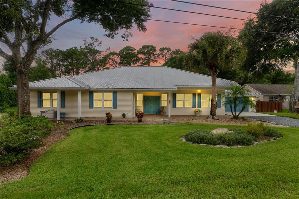 a front view of a house with swimming pool having outdoor seating