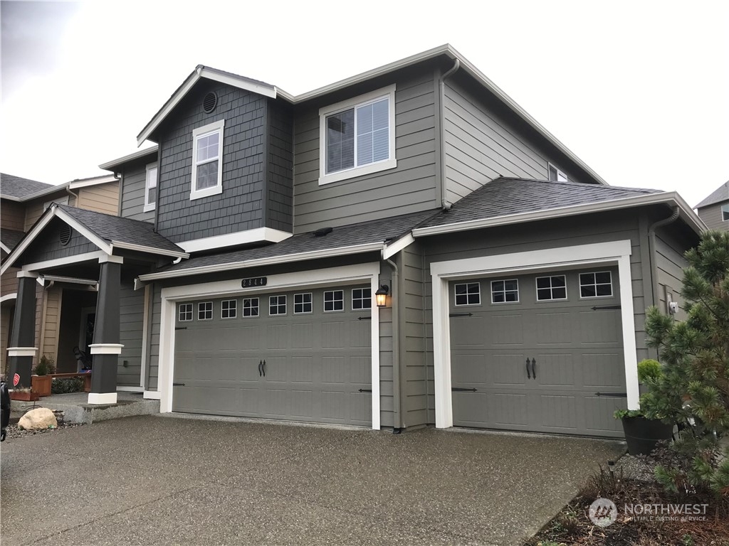 a front view of a house with garage