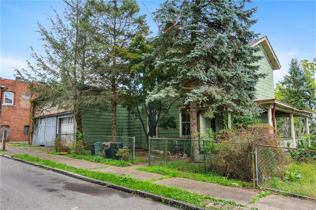 front view of a house with a tree