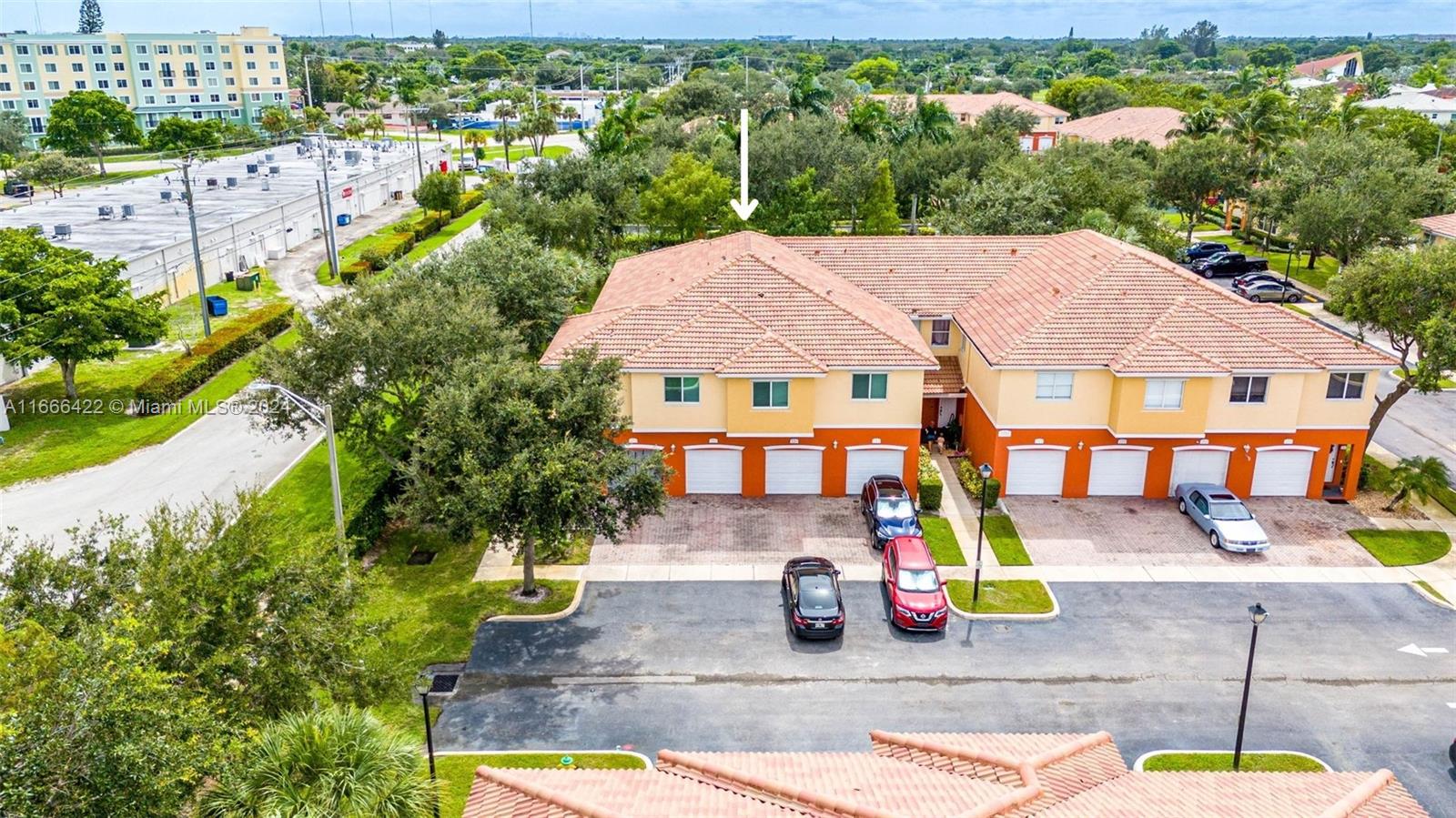 an aerial view of a house with a garden and swimming pool