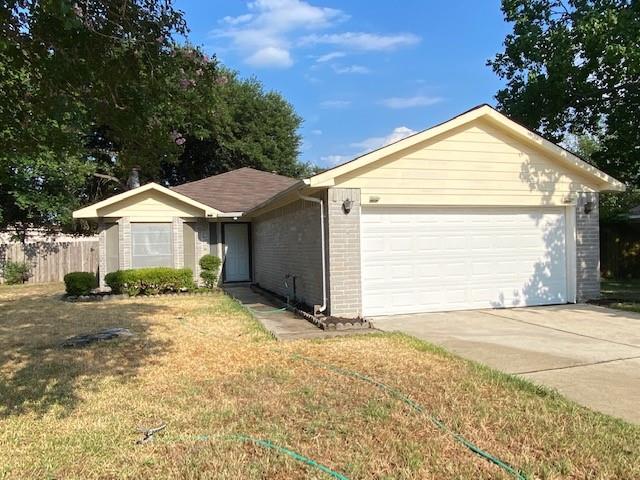 a view of a house with a yard and garage