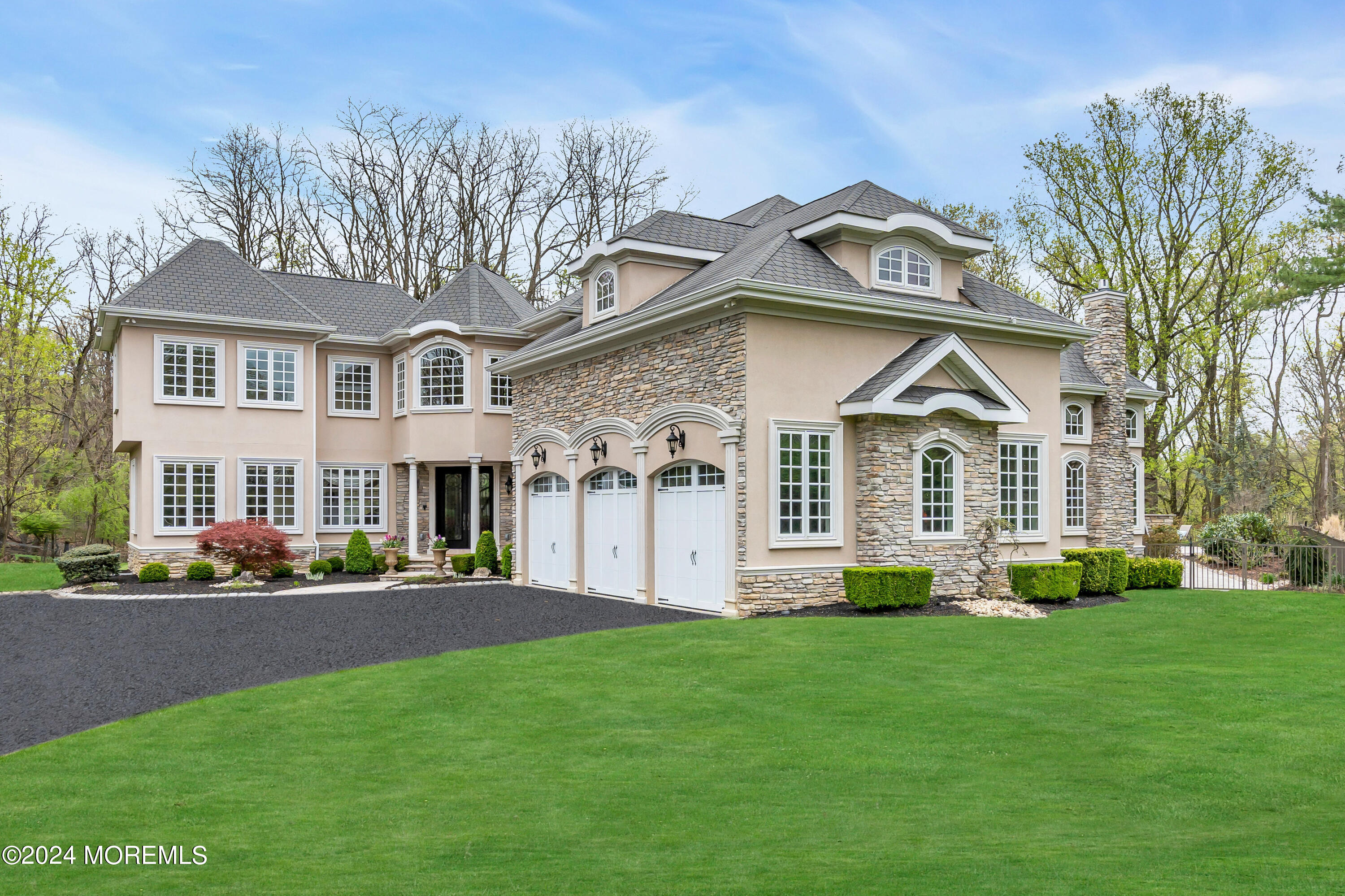 a front view of a house with a garden and plants