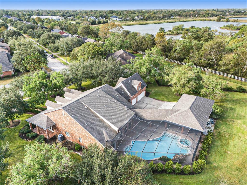 an aerial view of a house with a yard and lake view