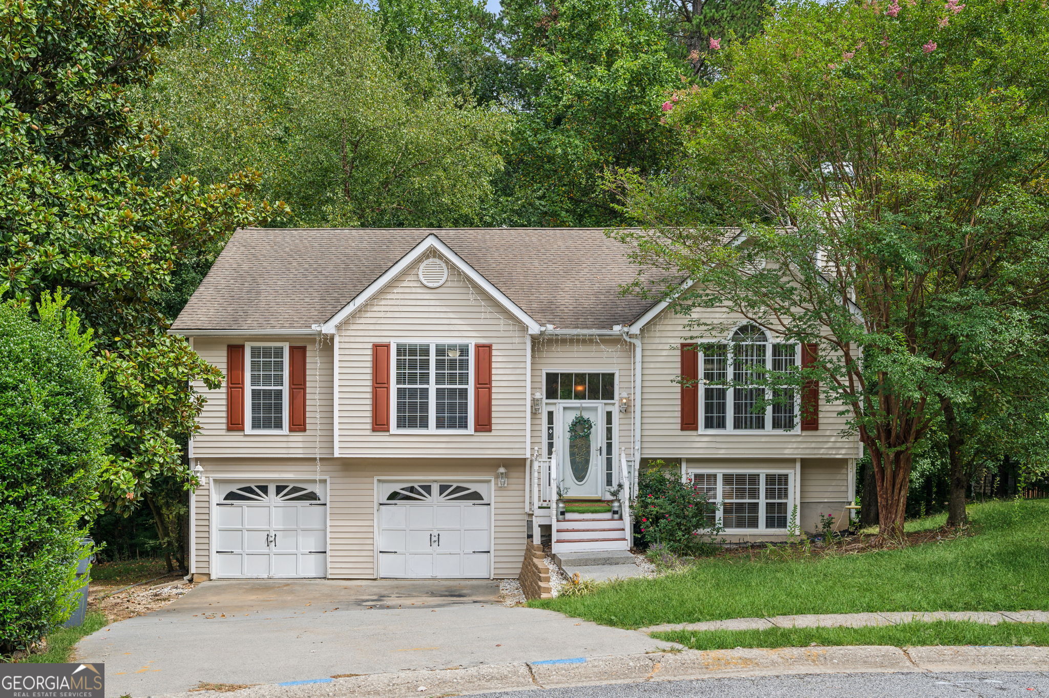 a front view of a house with a garden