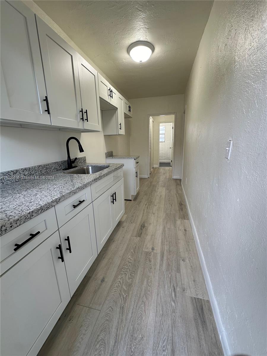 a kitchen with sink and cabinets