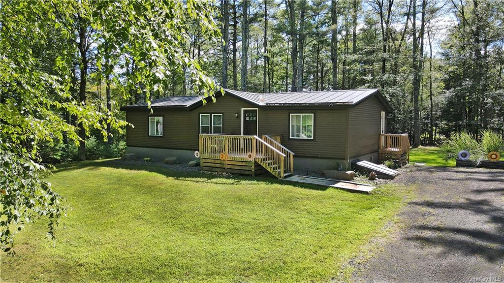 a view of a house with backyard porch and sitting area