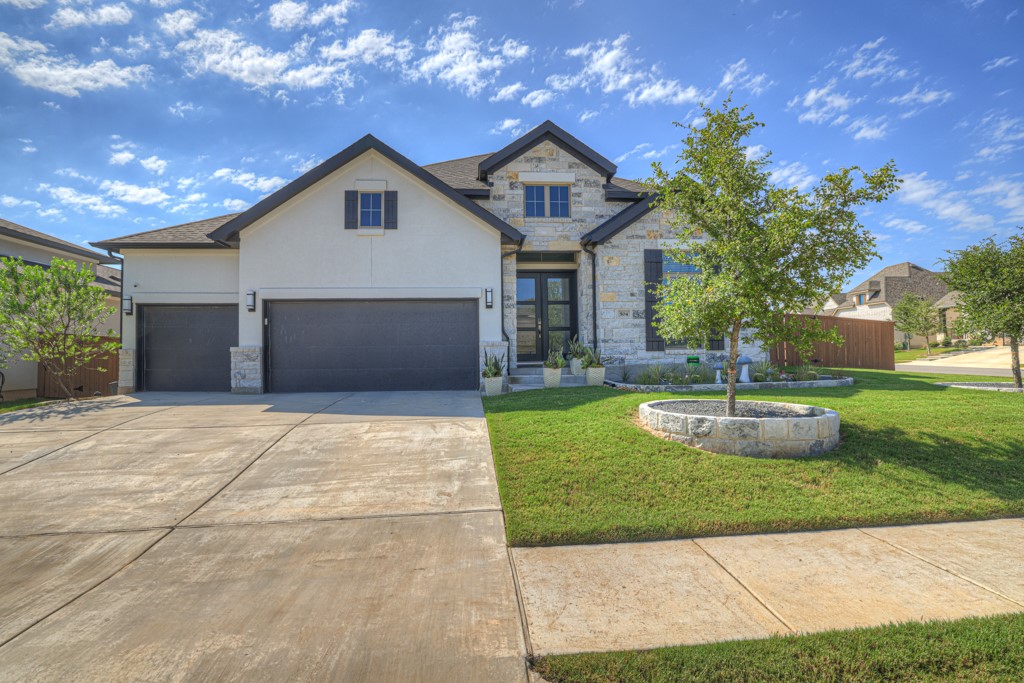 a front view of a house with a yard and garage