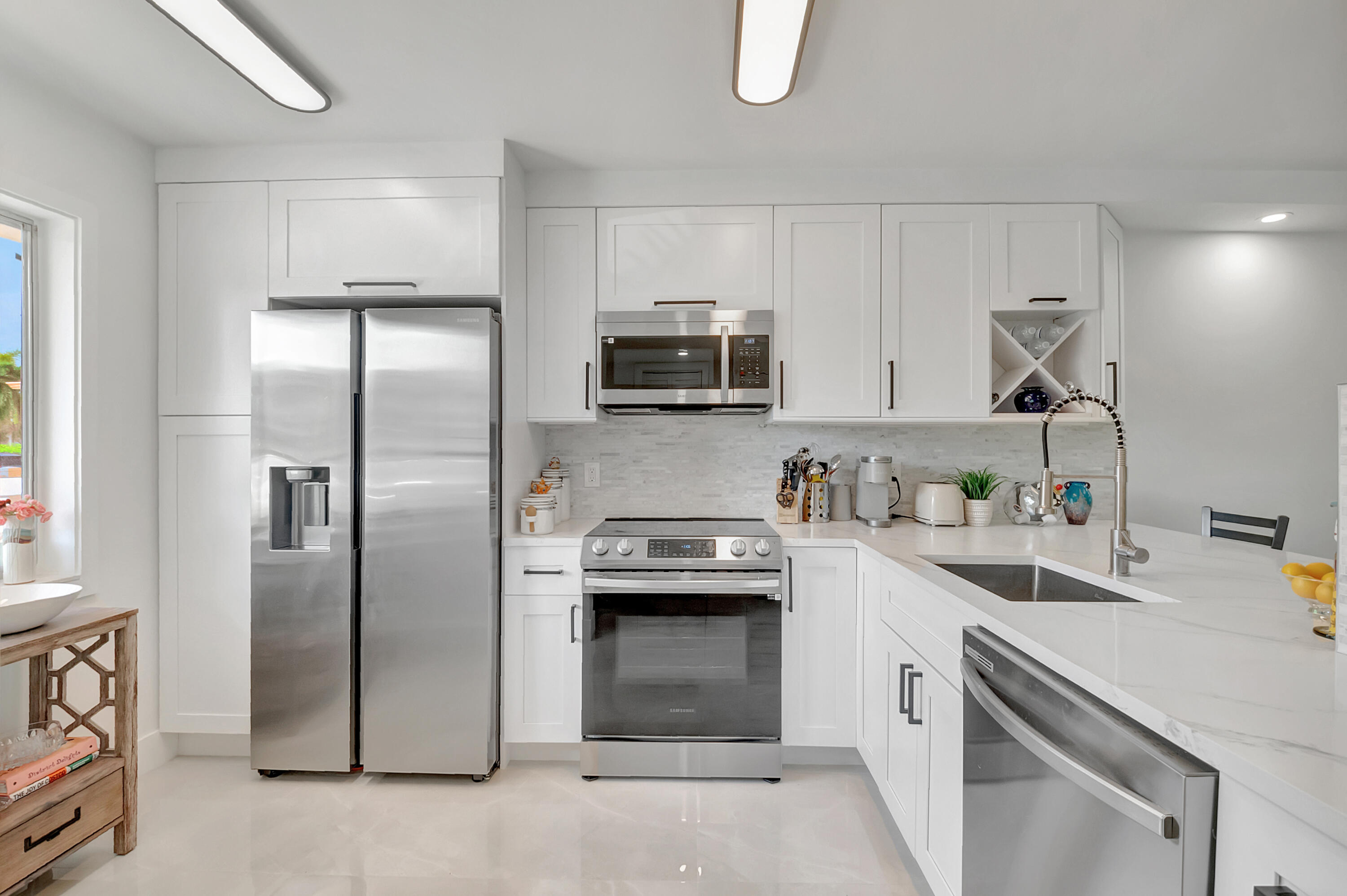 a kitchen with a sink and a stove top oven