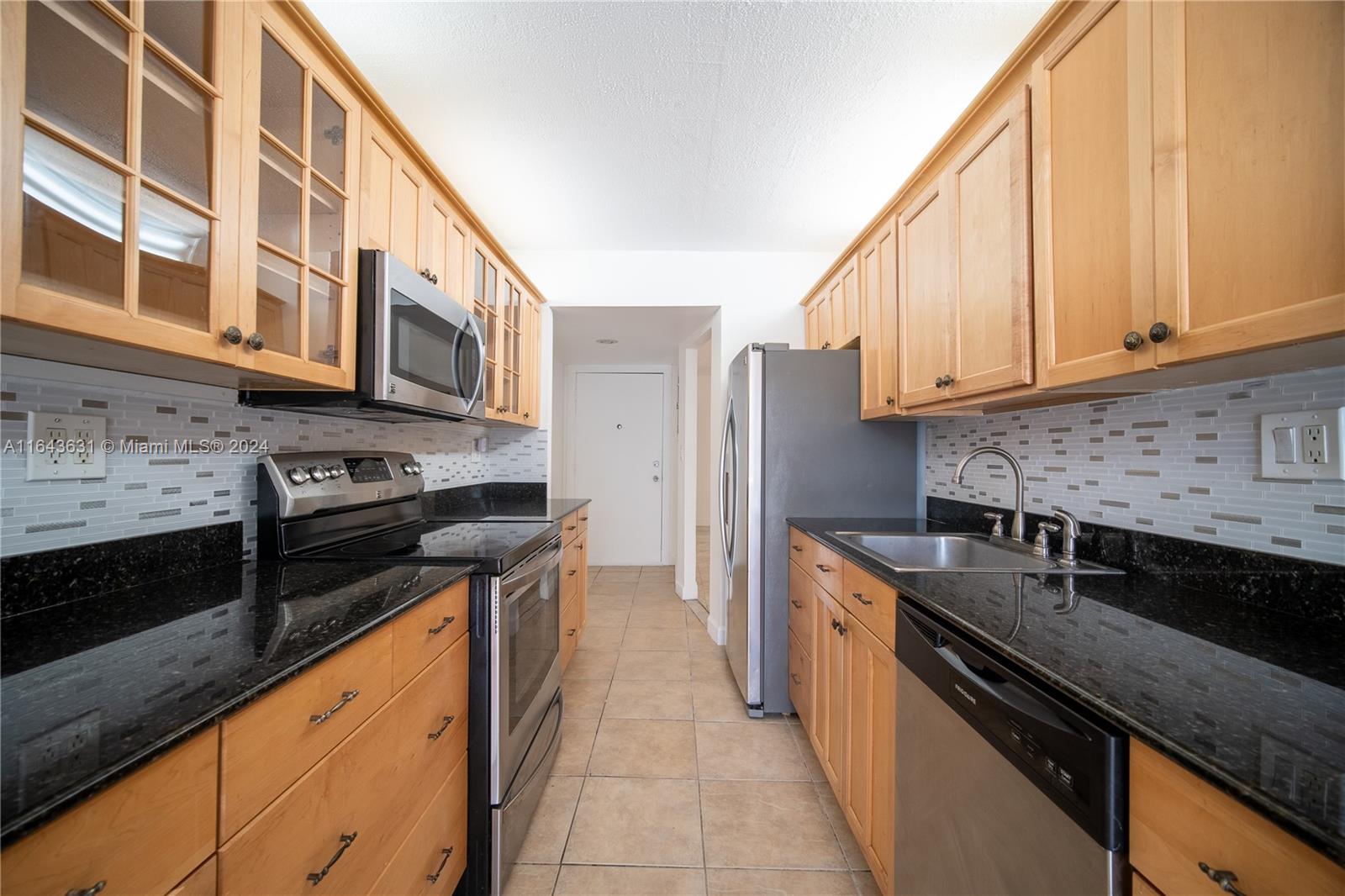 a kitchen with stainless steel appliances granite countertop a stove and a sink