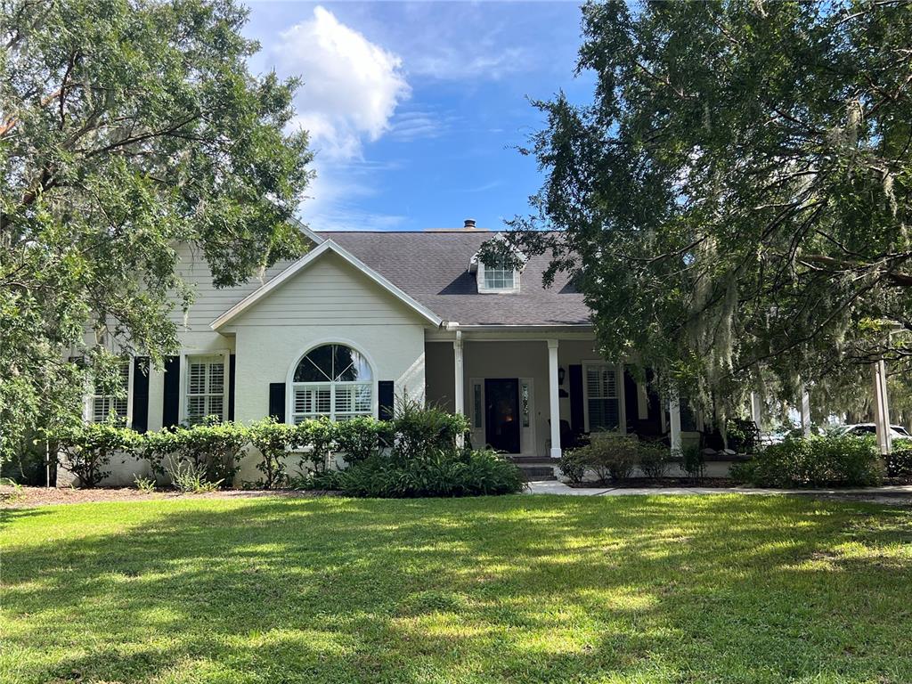 a front view of house with yard and green space