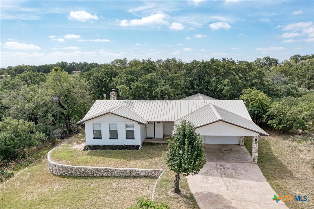 a aerial view of a house next to a yard