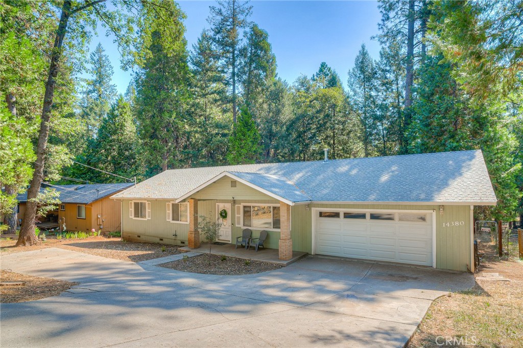 a aerial view of a house with a yard and garage