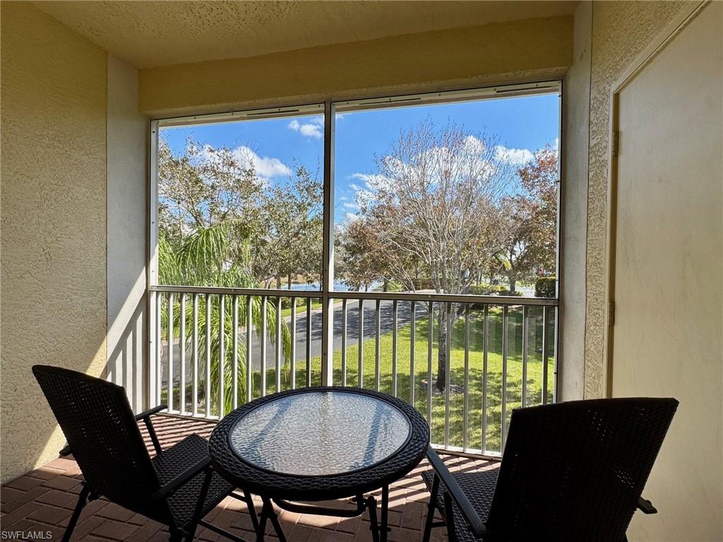 a view of a chairs and table in a balcony