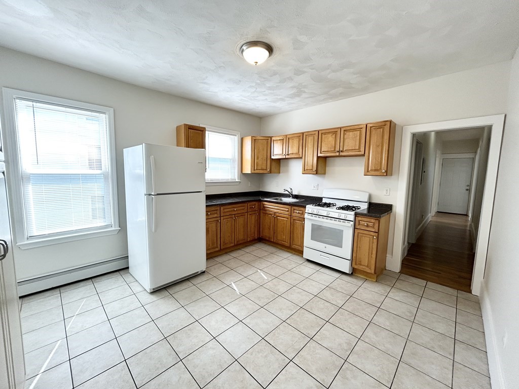 a kitchen with stainless steel appliances granite countertop a refrigerator sink and cabinets