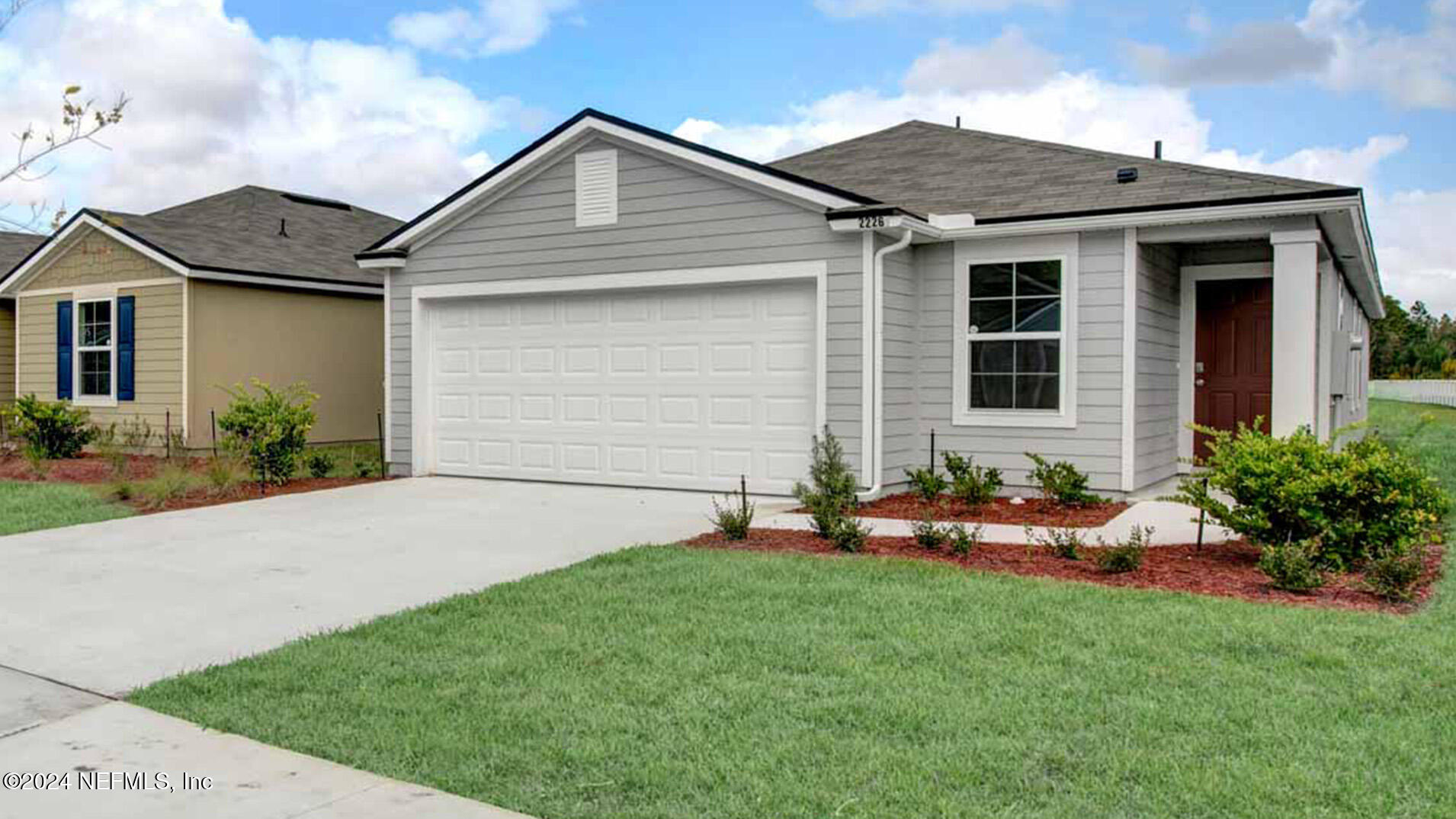 a front view of house with yard and green space