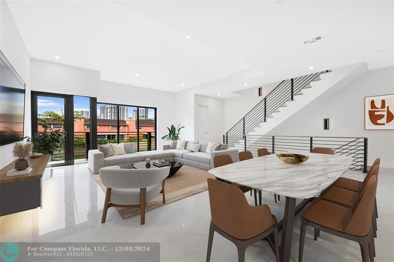 a living room with furniture a table and a potted plant