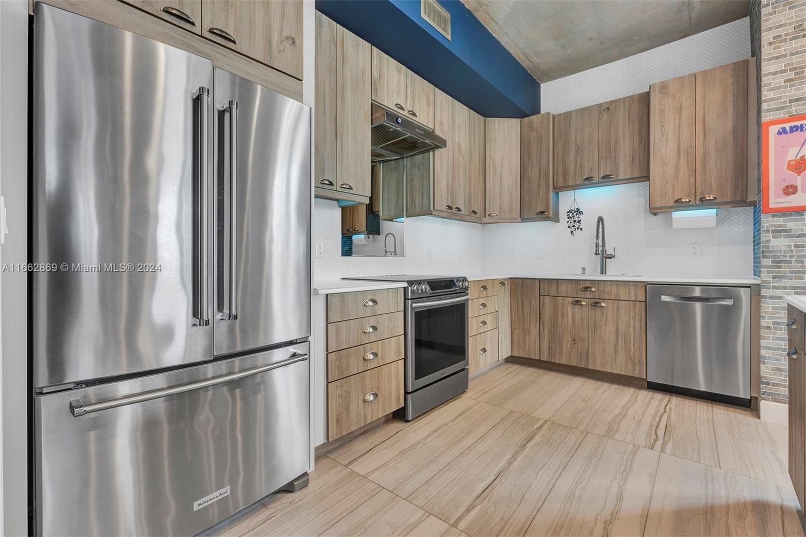 a kitchen with stainless steel appliances a refrigerator sink and cabinets