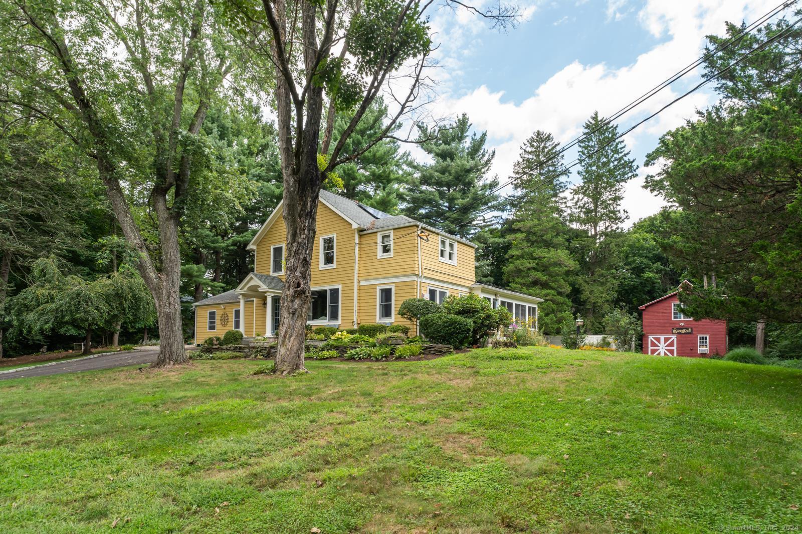 a front view of house with yard and green space