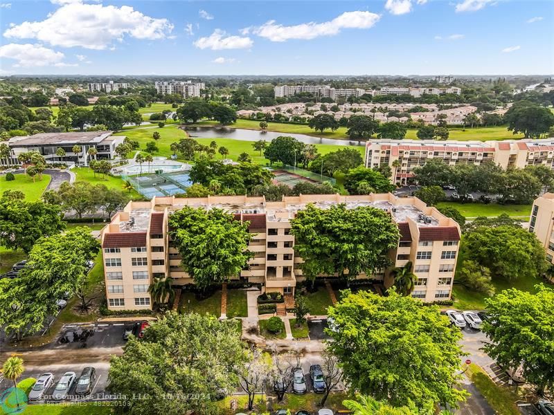 an aerial view of residential houses with outdoor space and river