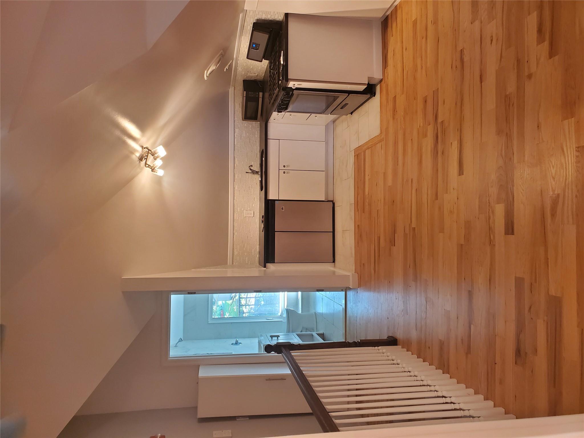 a view of a room with a furniture and wooden floor