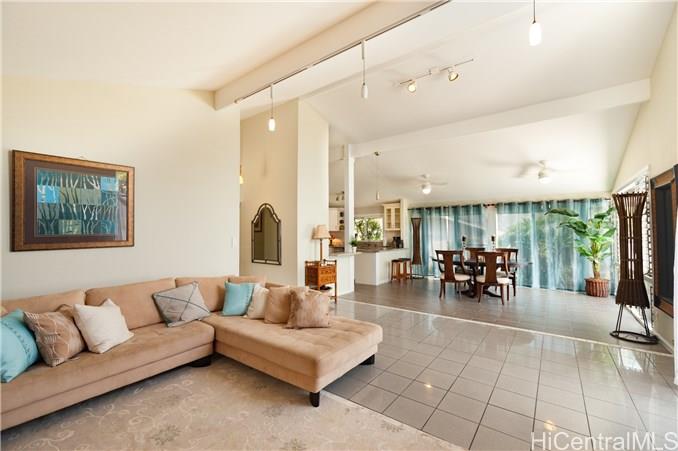 a living room with furniture and large windows