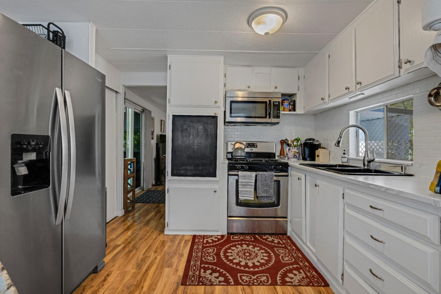 a kitchen with stainless steel appliances a refrigerator stove and sink